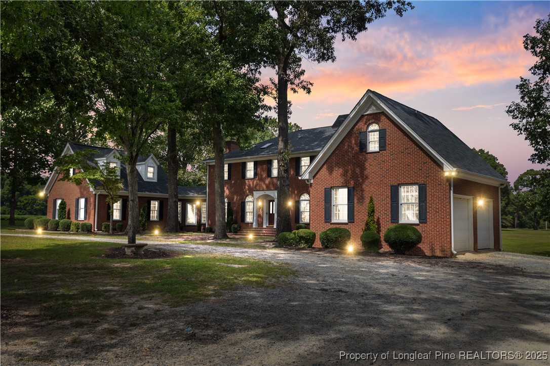 387 3 Bridge Road Dunn, NC 28334 - Photo 2 of 49 a front view of a house with a yard