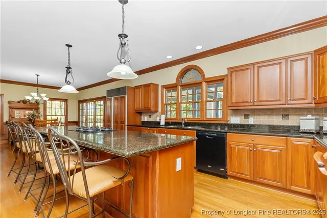 a kitchen with stainless steel appliances granite countertop a stove and cabinets