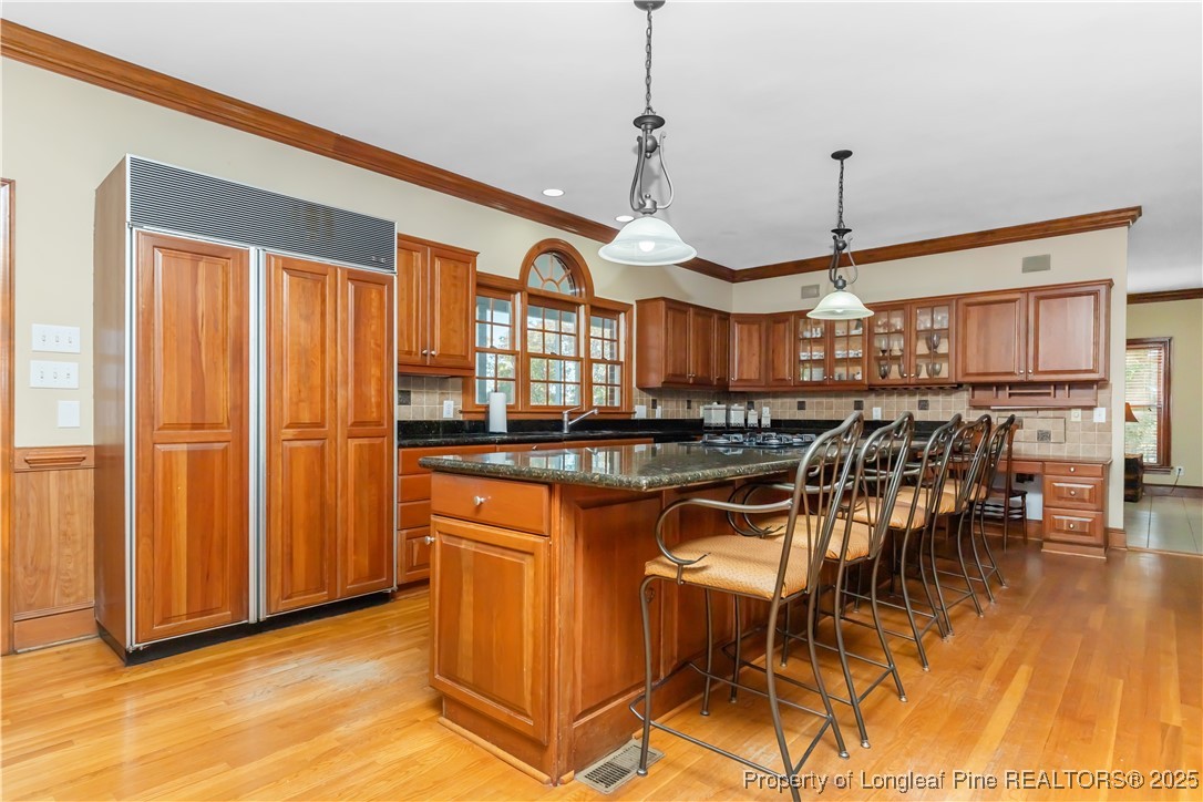 387 3 Bridge Road Dunn, NC 28334 - Photo 22 of 49 a view of a kitchen with furniture and wooden floor