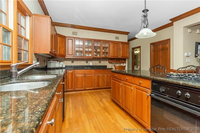 a kitchen with wooden cabinets and stainless steel appliances