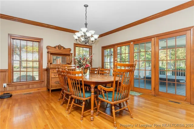 a view of a dining room with furniture wooden floor and chandelier