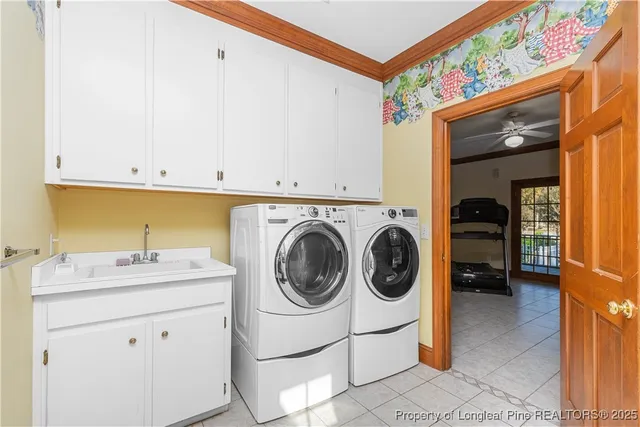 a utility room with sink dryer and washer