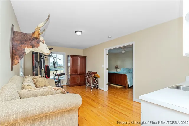 a living room with furniture and a wooden floor
