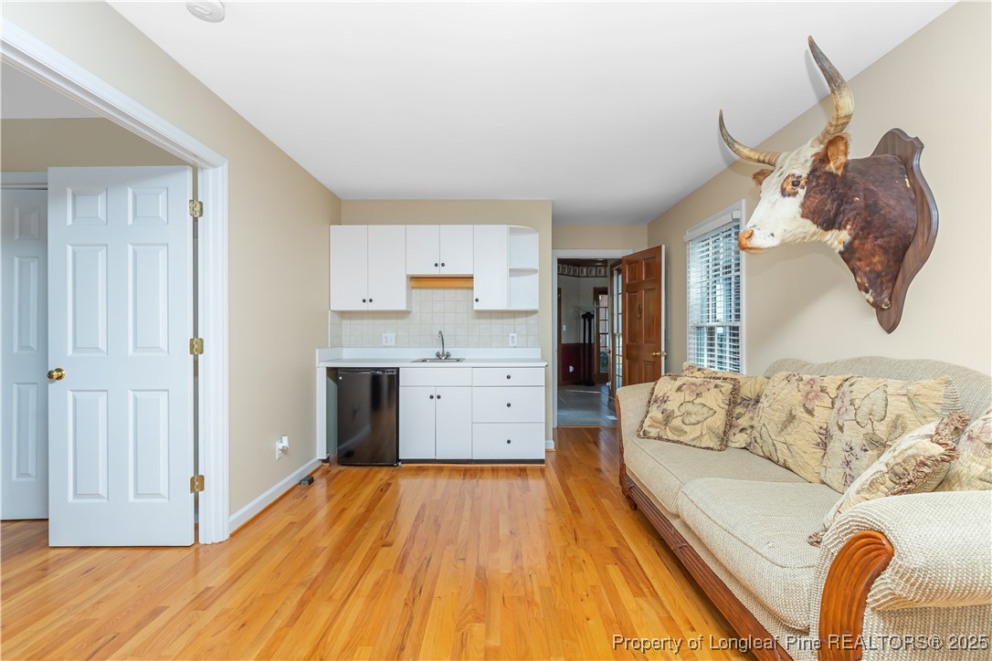 387 3 Bridge Road Dunn, NC 28334 - Photo 35 of 49 a living room with furniture and a wooden floor