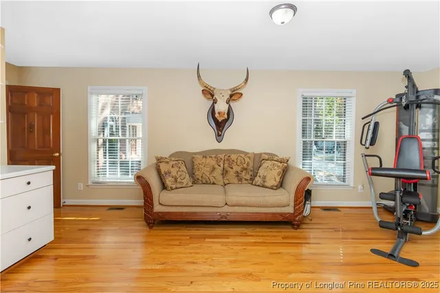 a living room with furniture window and wooden floor
