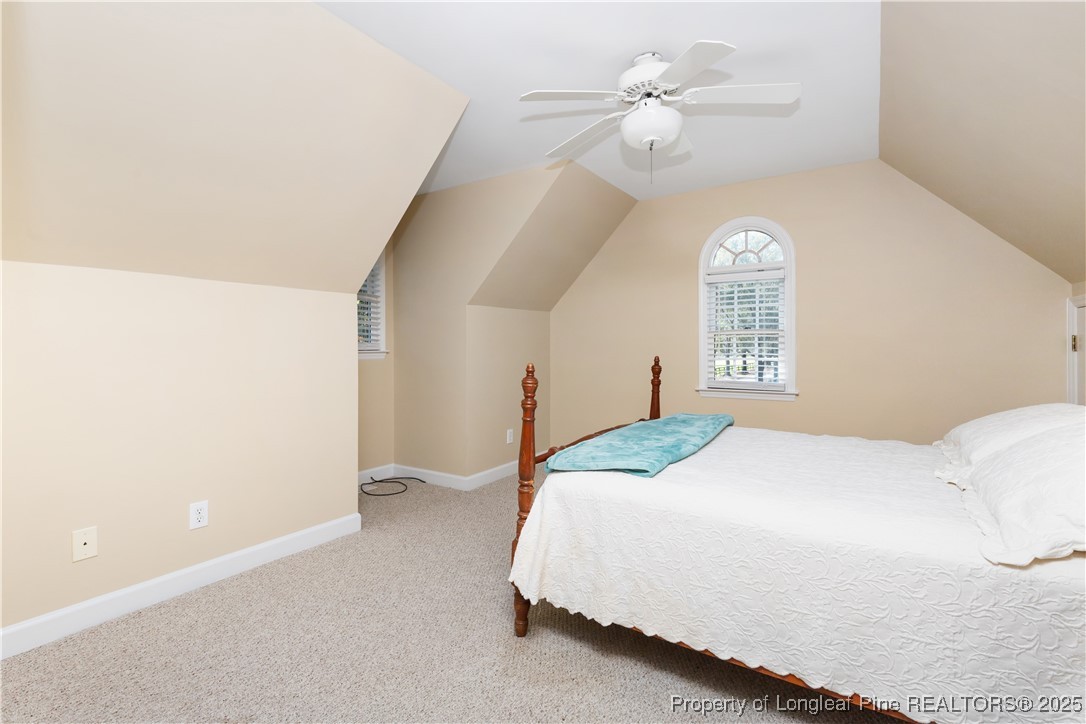 387 3 Bridge Road Dunn, NC 28334 - Photo 40 of 49 a bedroom with a bed and a chandelier