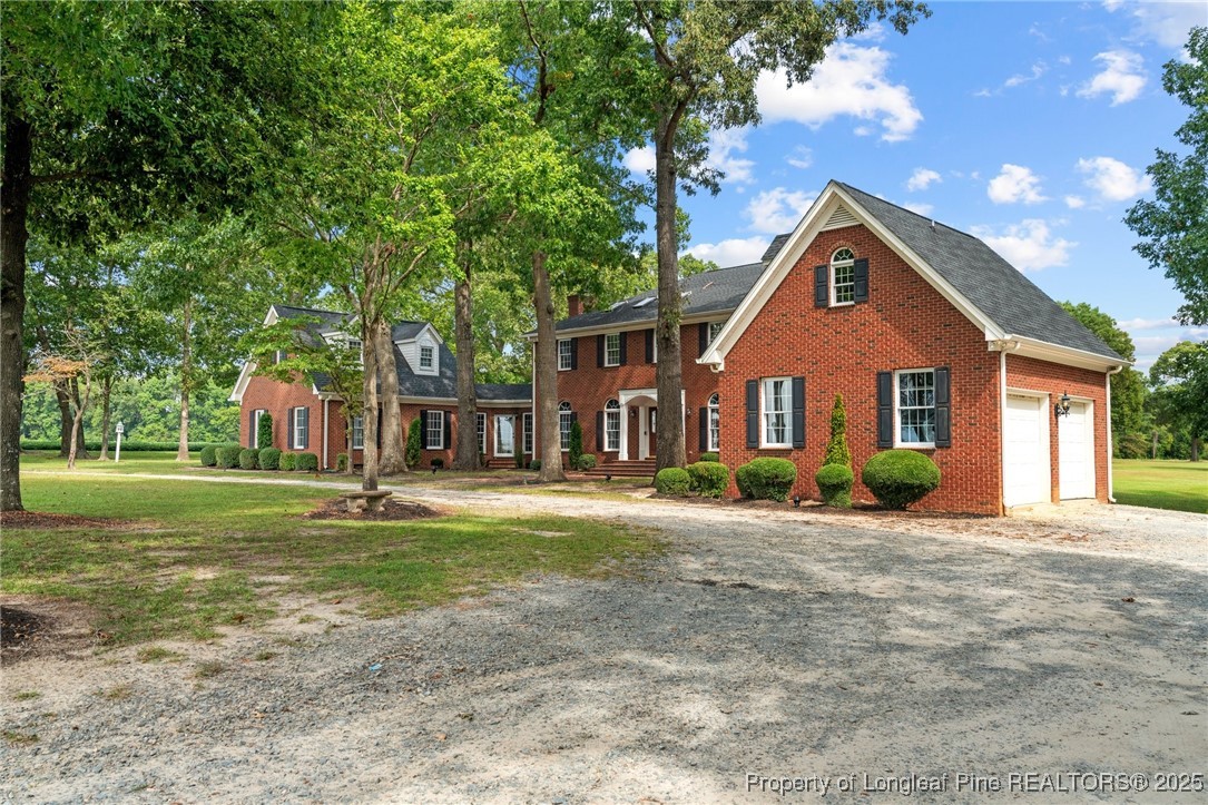 387 3 Bridge Road Dunn, NC 28334 - Photo 4 of 49 a front view of a house with a yard