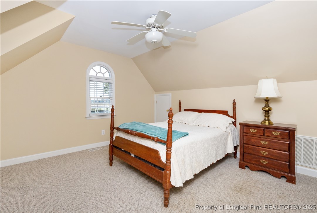 387 3 Bridge Road Dunn, NC 28334 - Photo 41 of 49 a bedroom with a bed and a chandelier