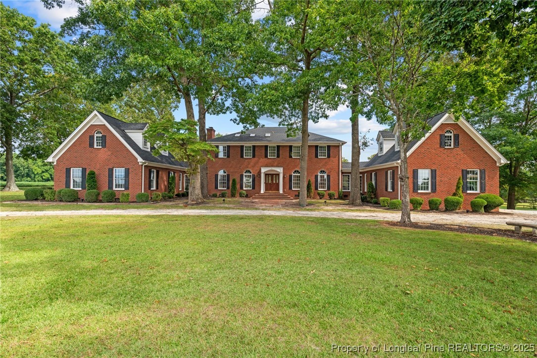 387 3 Bridge Road Dunn, NC 28334 - Photo 5 of 49 a front view of a house with swimming pool having outdoor seating