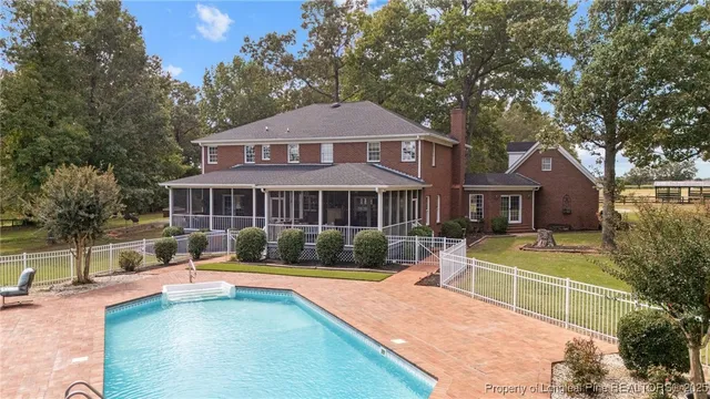 a view of a house with swimming pool and a yard