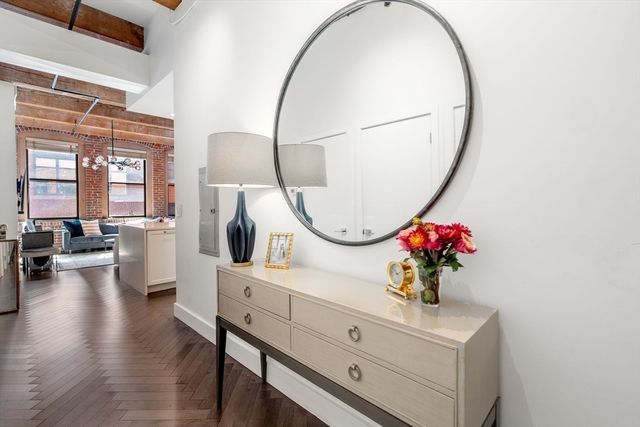 a living room with furniture and a mirror