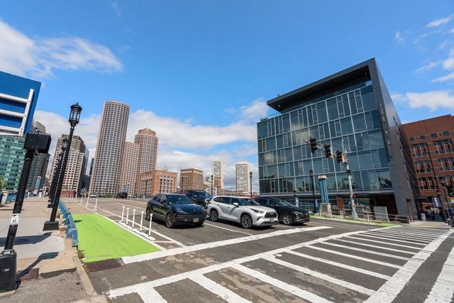 a view of a building with cars parked in front of a house