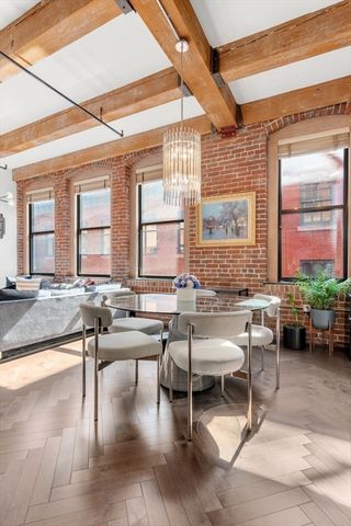 a living room with couches a coffee table and a large window with garden view