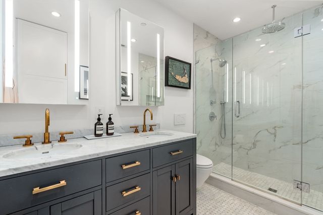 a bathroom with a granite countertop sink mirror and double