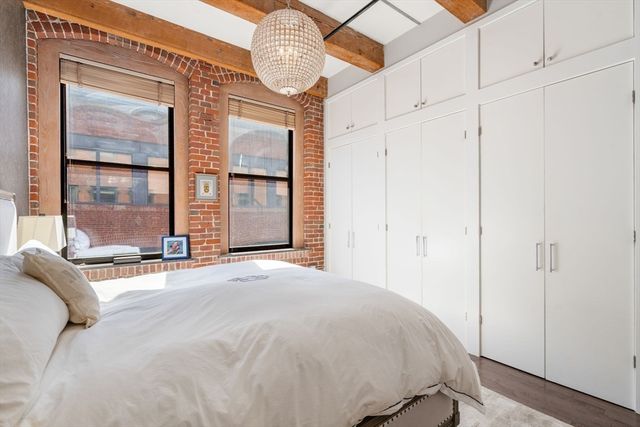 a bed room with a bed mirror and a window