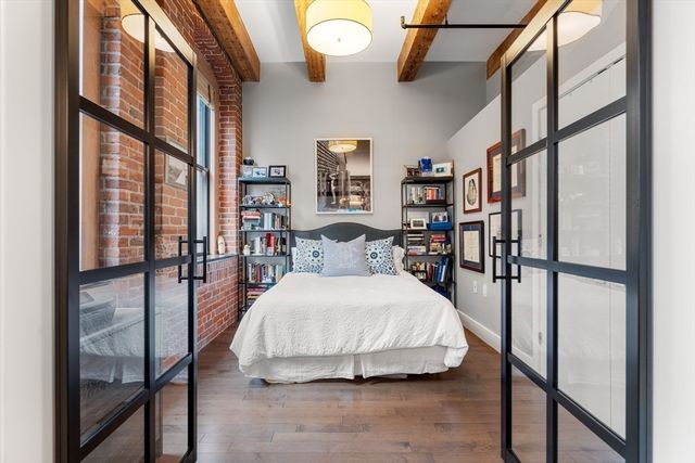 a bedroom with a bed and a large window with the outer view
