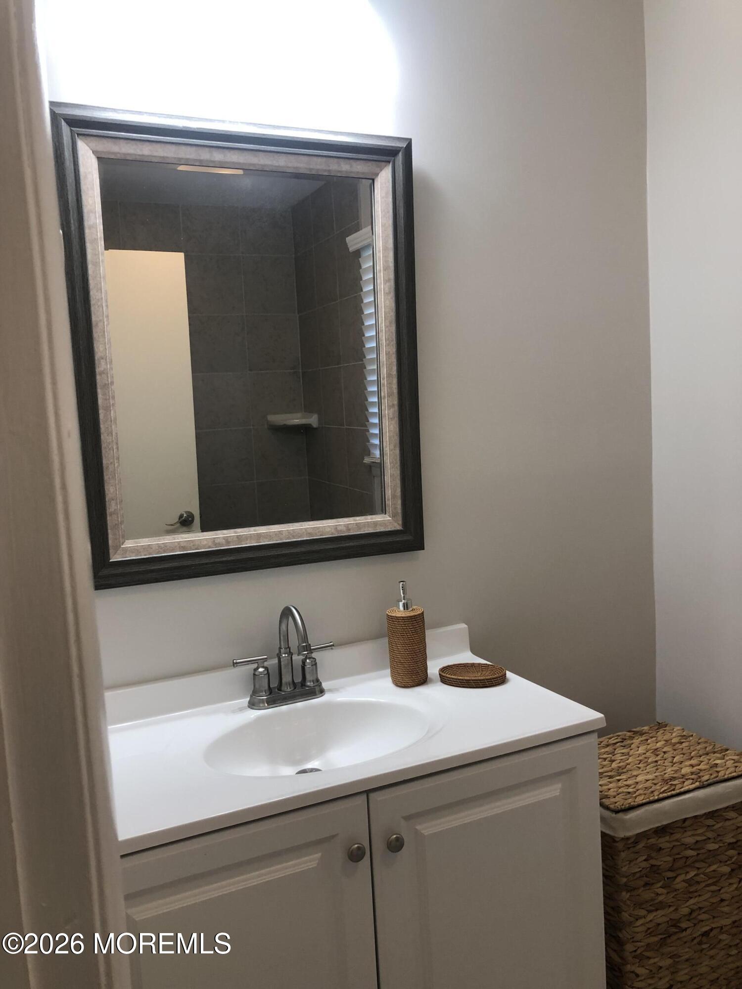 6 Dickinson Road Brick, NJ 08724 - Photo 15 of 17 a bathroom with a sink and a mirror