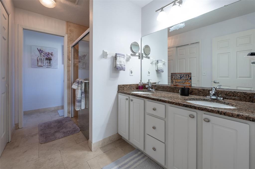 15143 Southwest 14th Avenue Road Ocala, FL 34473 - Photo 22 of 53 a bathroom with a double vanity sink and mirror