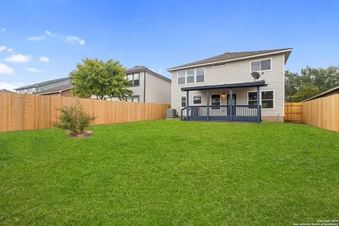 a view of a house with a yard and sitting area