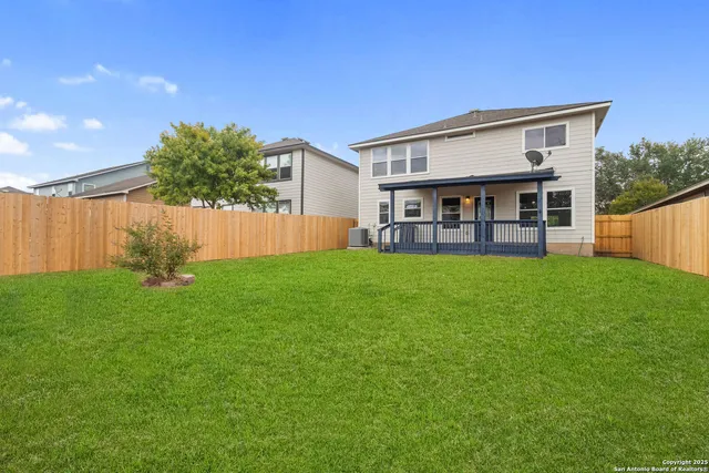 a view of a house with a yard and sitting area