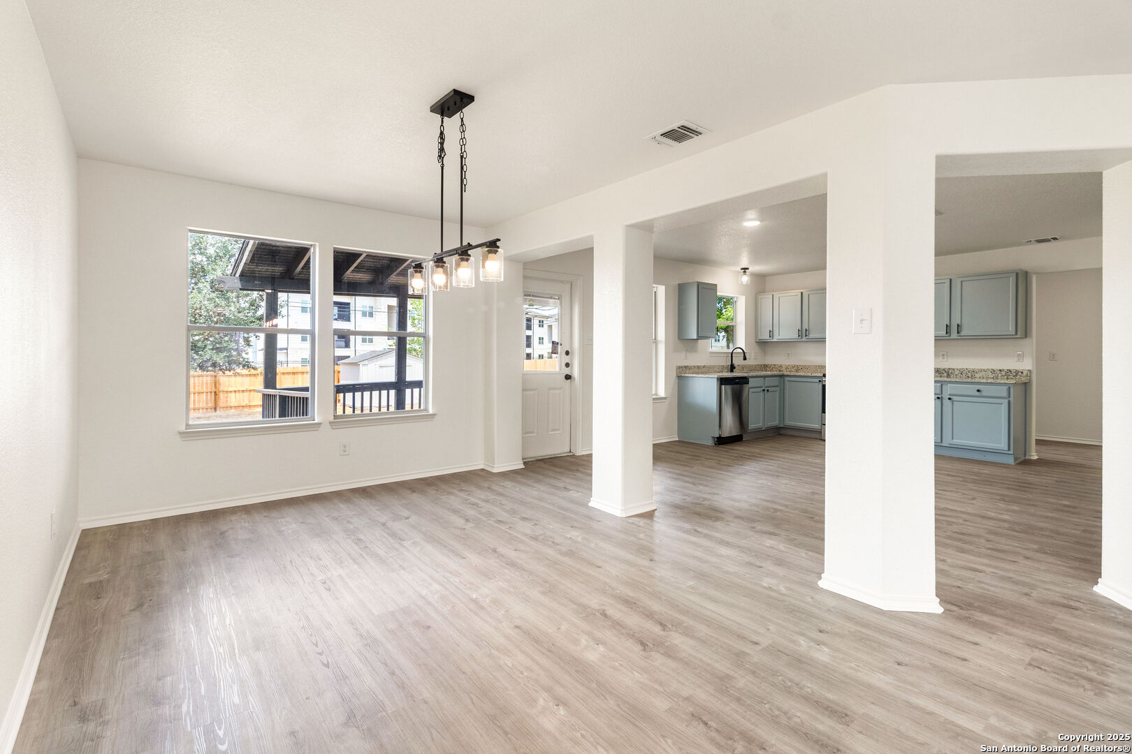 5015 Badland Beacon Converse, TX 78109 - Photo 6 of 23 a view of a big room with wooden floor kitchen view and windows