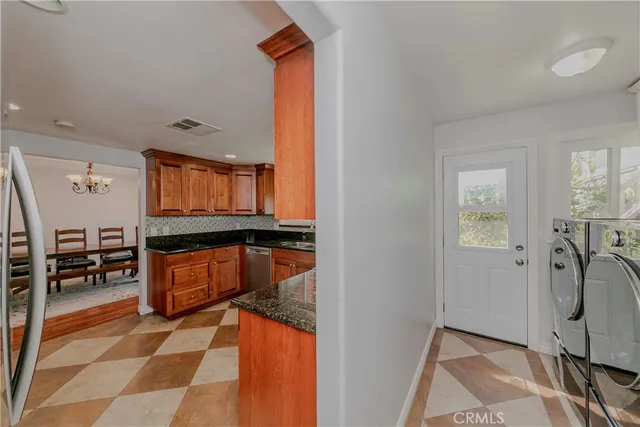 a living room with furniture a flat screen tv and a sink