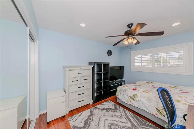 a bedroom with a bed and wooden floor