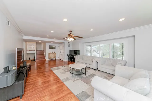 a living room with furniture dining table and a large window