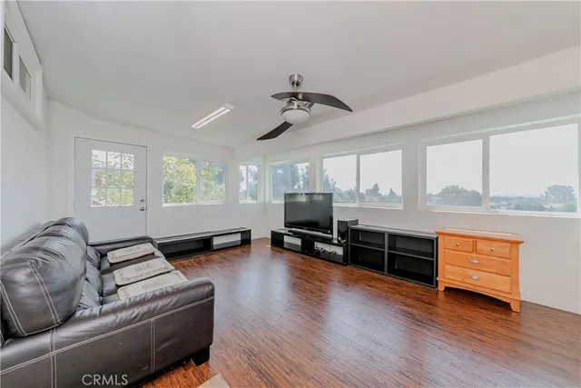 a living room with furniture window and wooden floor
