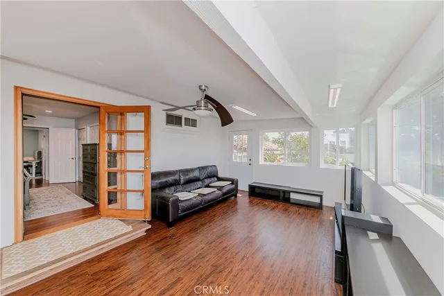 a living room with furniture gym equipment and a large window