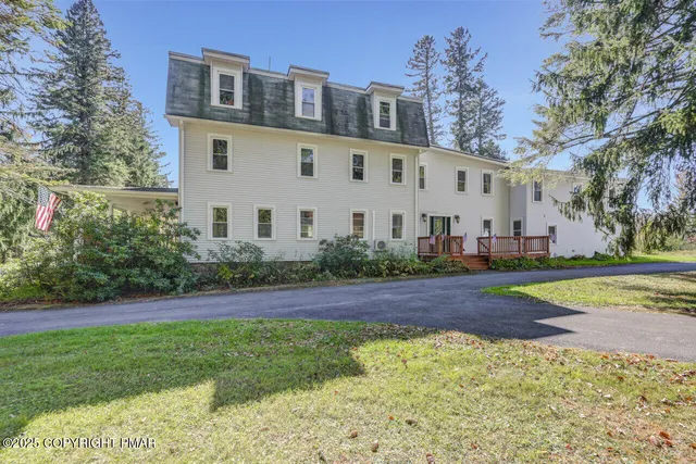 a front view of a house with a yard and a garage