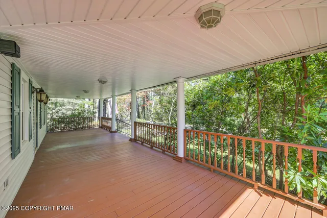 a dining room with lots of furniture wooden floor and chandelier
