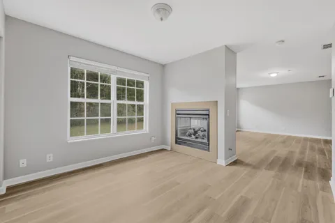 a view of a hallway with closet and wooden floor