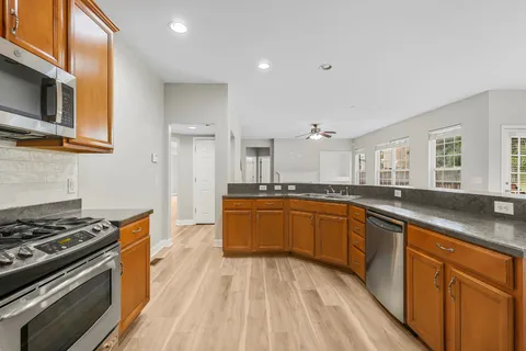a view of empty room with wooden floor and fireplace
