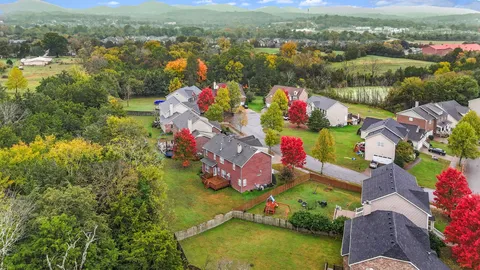 an aerial view of lake and residential houses with outdoor space