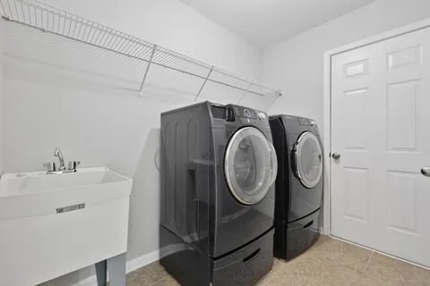 en suite bathroom with a sink and glass door