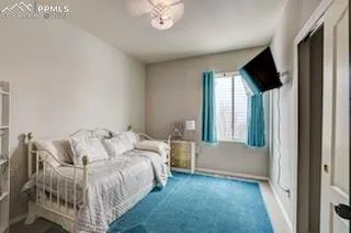 a bed sitting in a bedroom next to a window