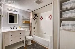 a bathroom with a bathtub shower sink vanity and toilet