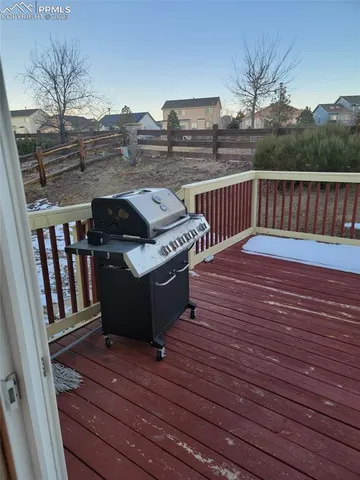 a view of a roof deck with wooden floor and fence