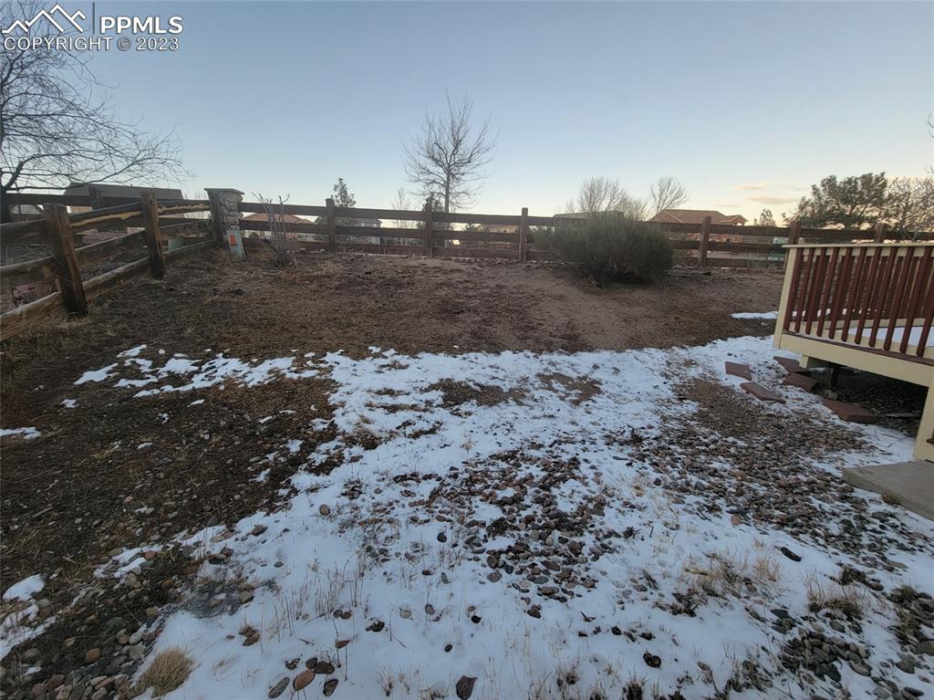 12264 Point Reyes Drive Peyton, CO 80831 - Photo 22 of 24 a view of a dry yard with wooden fence