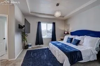 a bedroom with bed and a large window