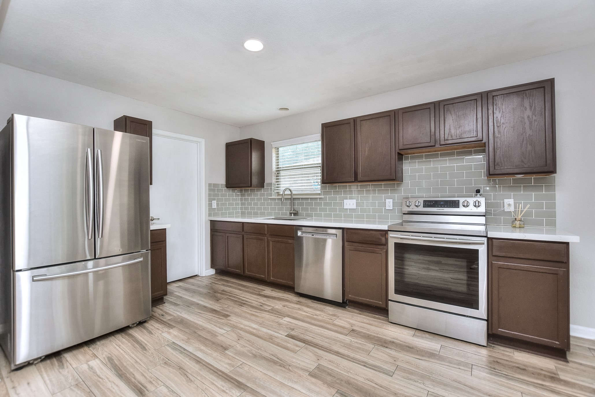 74 Jan Lane Georgetown, TX 78626 - Photo 18 of 31 a kitchen with stainless steel appliances granite countertop a refrigerator microwave and stove top oven