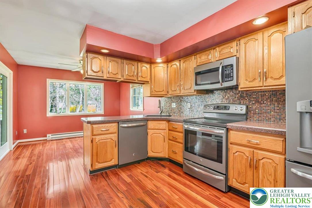 1210 Bluestone Drive Bethlehem, PA 18017 - Photo 19 of 84 a kitchen with stainless steel appliances granite countertop a stove a sink and a microwave