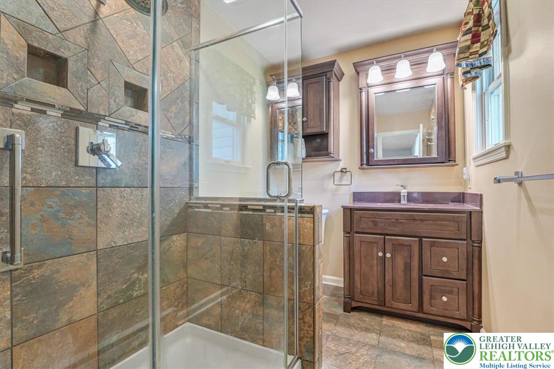 1210 Bluestone Drive Bethlehem, PA 18017 - Photo 39 of 84 a bathroom with a granite countertop sink a mirror and shower