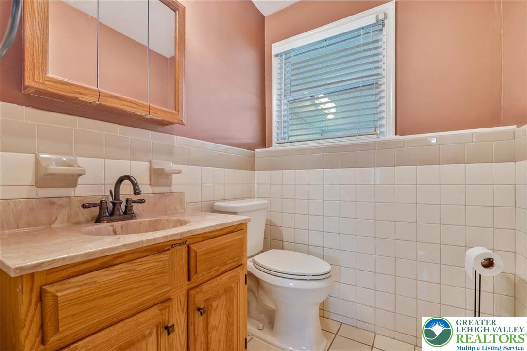 1210 Bluestone Drive Bethlehem, PA 18017 - Photo 54 of 84 a bathroom with a sink a toilet and mirror