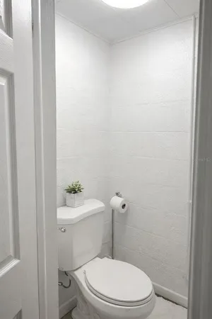 a white toilet sitting next to a white sink