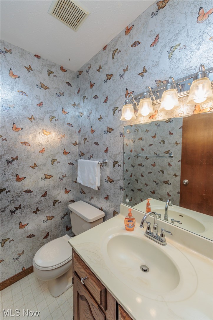 36085 Bainbridge Road Solon, OH 44139 - Photo 17 of 35 Bathroom featuring tile floors, toilet, and oversized vanity