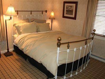 7 Miller Hill Road Provincetown, MA 02657 - Photo 12 of 30 a bed room with a bed and a night stand