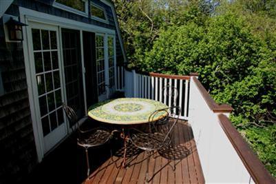 7 Miller Hill Road Provincetown, MA 02657 - Photo 17 of 30 a view of a balcony with table and chairs