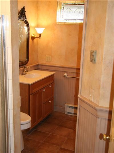 7 Miller Hill Road Provincetown, MA 02657 - Photo 28 of 30 a bathroom with a sink a toilet and a mirror
